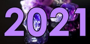 2021 written in large numbers over a photo of amethysts on a dark background